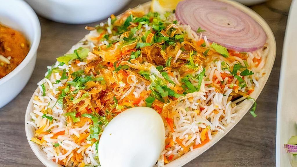 Egg Biryani · Egg marinated in spices and herbs and cooked with saffron flavored aromatic basmati rice. Spiced to order and served with whipped yogurt sauce blended with herbs and finely grated cucumbers. Served with raita and salan.