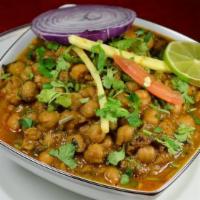 Chana Masala · Zesty garbanzo bean curry with sauteed onions, tomatoes, garlic, and ginger, garnished with ...