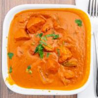 Chicken Tikka Masala · Tandoori chicken chunks cooked in rich red creamy tomato lightly spiced sauce. Served with b...