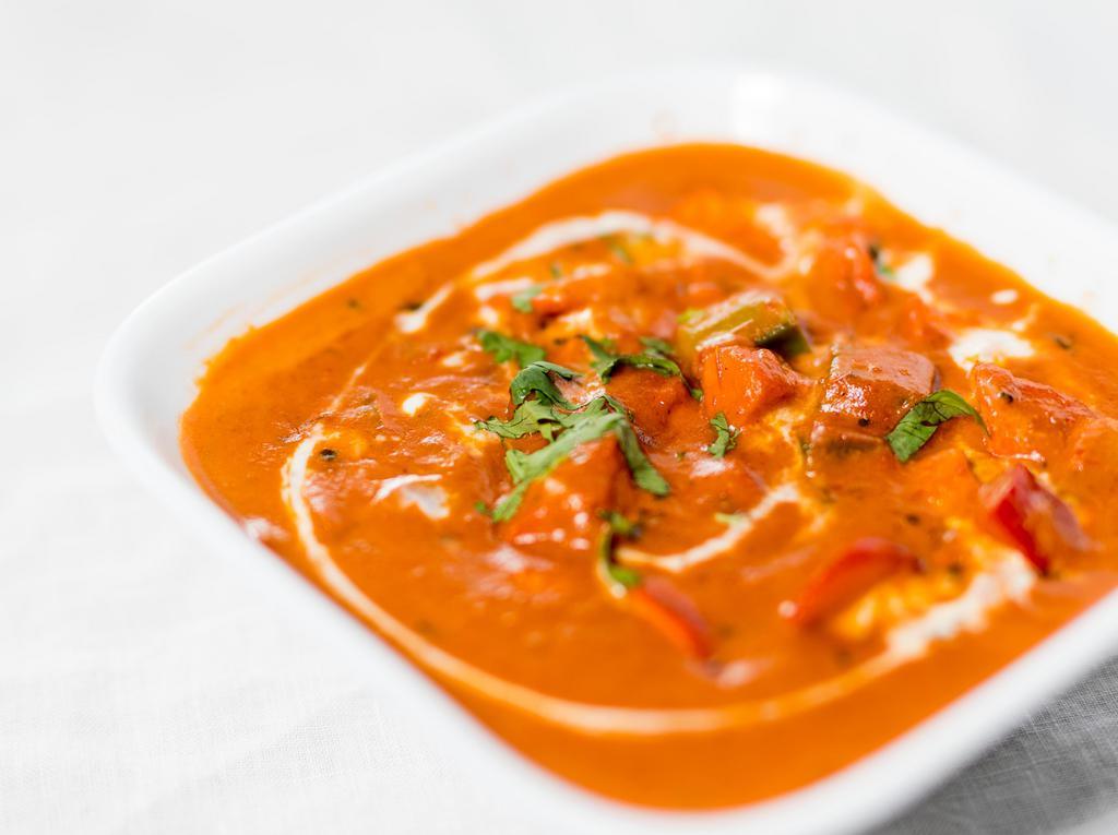 Butter Chicken · Boneless chicken tenders cooked in a touch of butter and creamy tomato sauce. Served with basmati rice.