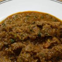 Lamb Curry · Boneless lamb cooked in tomatoes, onions, fresh herbs, and spices. Served with basmati rice.