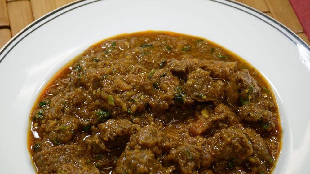 Lamb Curry · Boneless lamb cooked in tomatoes, onions, fresh herbs, and spices. Served with basmati rice.