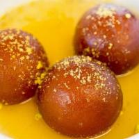 Gulab Jamun · A traditional milk based pastry balls served warm in a honey flavored syrup.