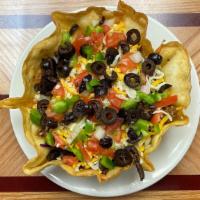 Taco Salad · Spicy ground beef, black olives, onions, tomatoes, Cheddar cheese, over fresh greens in a cr...
