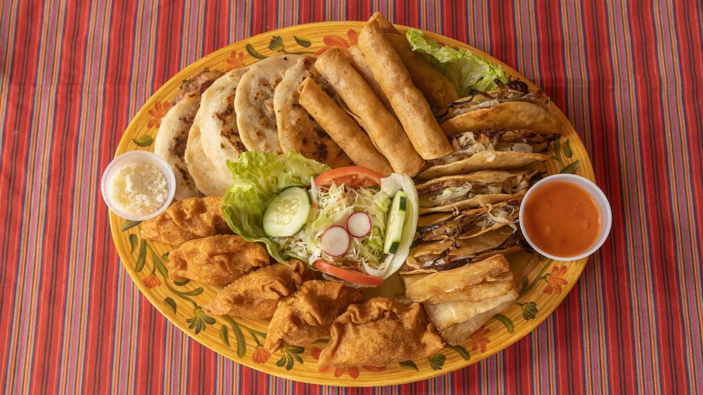 Combo Delicias · Serves three (3) or four (4) people. Five (5) shredded beef dobladas, five (5) pupusas with filing, five (5) taquitos (chicken, beef or potato), five (5) pork or vegetable pastelitos, fried cassava with curtido salad.