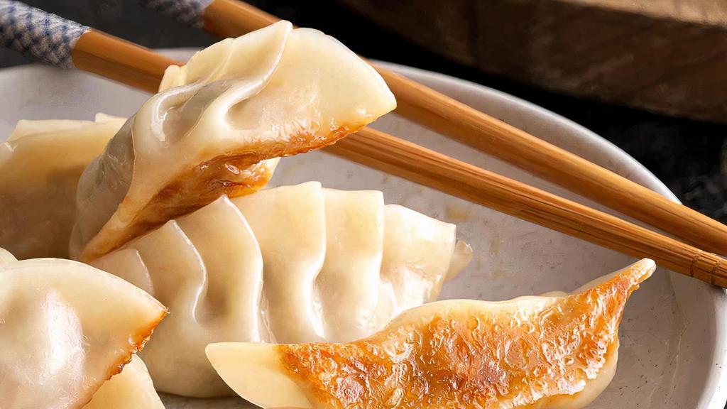 Gyoza (6) · Pan-fried chicken pot stickers filled with and with dipping sauce