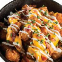 Loaded Tater Tots · Crispy, golden tater tots loaded with cheddar cheese sauce, ranch, bacon, and chives.  592 c...