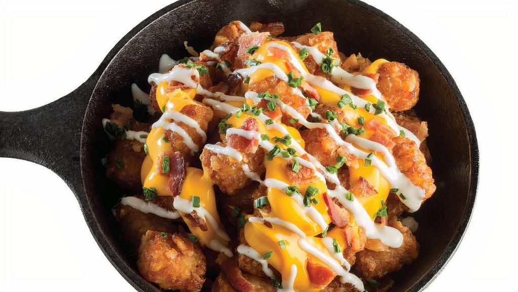 Lg Loaded Tater Tots · Crispy, golden tater tots loaded with cheddar cheese sauce, ranch, bacon, and chives.  1006 cal.