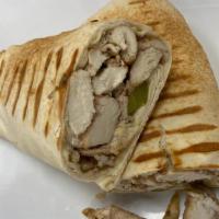 Chicken Shawarma · Oven roasted chicken shawarma, garlic and pickles raped in pita bread.
