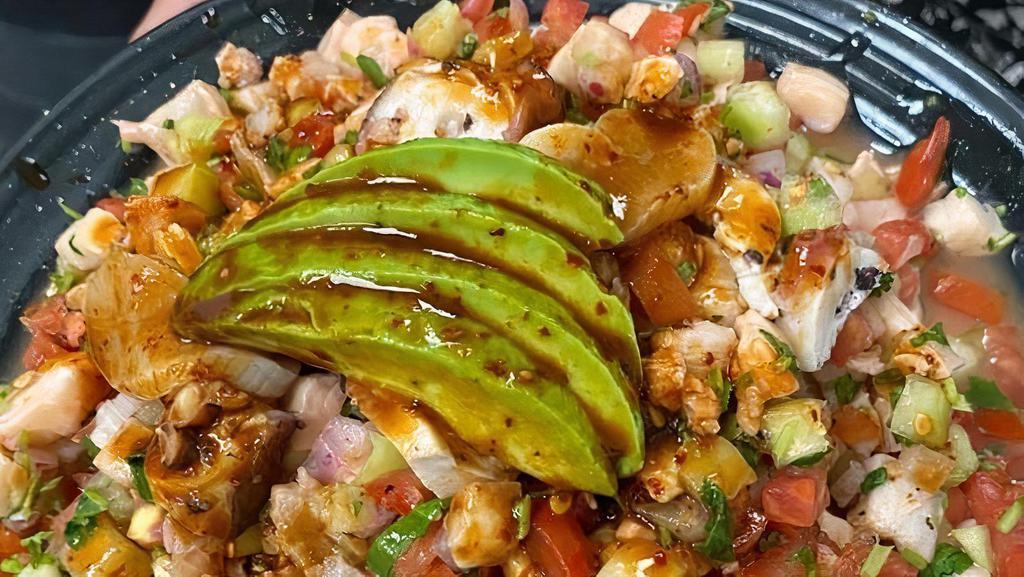 Ceviche Mixto · Fresh tilapia and shrimp marinated in lime juice, octopus, and cayo de hacha (Mexican scallop), mixed with cucumbers, tomatoes, red onions, cilantro and avocados, served cold with our special house sauce.