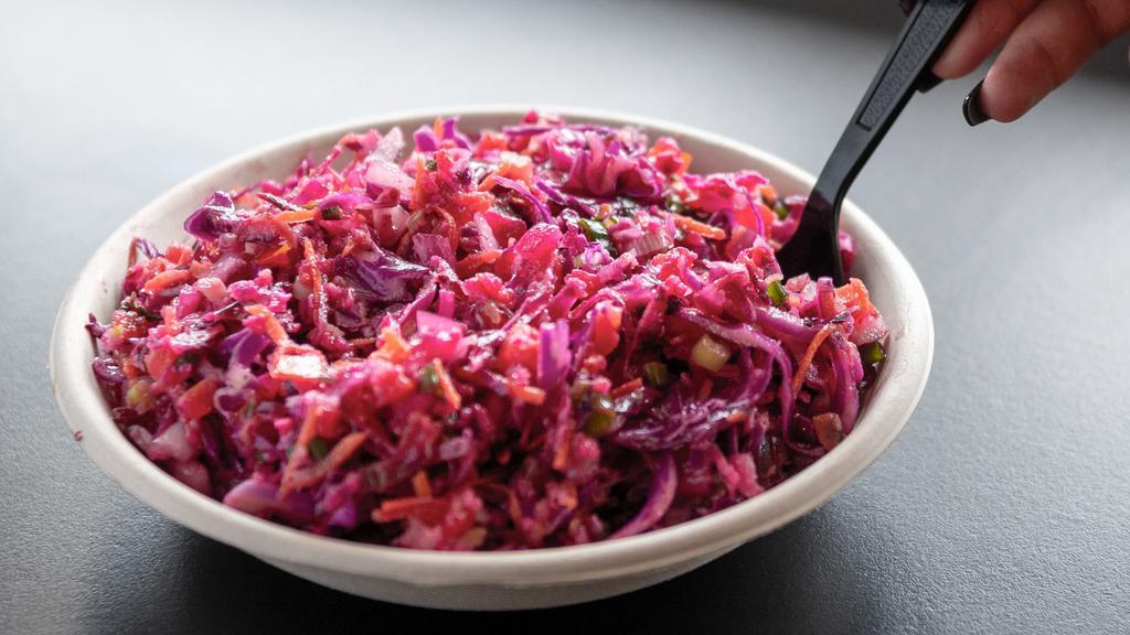 Red Cabbage Salad · Freshly cut red cabbage, tomatoes, green onions, red onions and freshly cooked quinoa with our homemade Tabouli dressing.