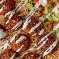 Falafel Over Rice · Lettuce tomato onions cucumber 
White sauce & hot sauce