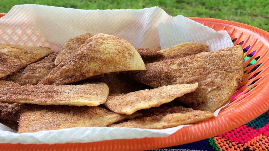 Churros Chips · Fried tortilla chips dusted with cinnamon sugar powder with a choice of hazelnut chocolate drizzle.