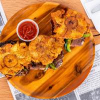 Tostone Sliders Sandwich · 3 crispy fried pressed Plantains. Served with your choice of smoked meat chicken, brisket, p...