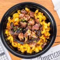 Jerk Brisket Over Mac · Jerk brisket chopped over our signature mac & cheese then drizzled with our jerk sauce