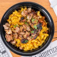 Jerk Chicken Over Mac · Boneless grilled Jerk chicken thighs  chopped over our signature mac & cheese then drizzled ...