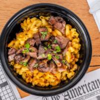 Jerk Pork Over Mac · Jerk pork chopped over our signature mac & cheese then drizzled with our jerk sauce
