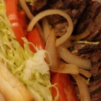 Rib-Eye Steak Sandwich · Our grilled rib-eye steak is served with lettuce, tomatoes and grilled onions on 6” French b...