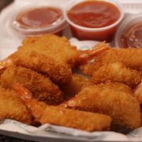One Pound Of Shrimp · Thirteen lightly breaded and fried jumbo shrimp are served with two sides of cocktail sauce.