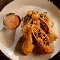Hill Country Egg Rolls · Smoked brisket, corn, cheddar, black beans, hickory sauce