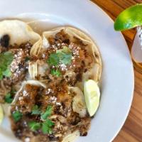 Street Tacos · 3 corn tortillas topped with your choice of shredded chicken or house pulled pork topped wit...