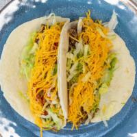 Hard Tacos · Garnished with lettuce, Texas sauce, diced onions and cheddar cheese