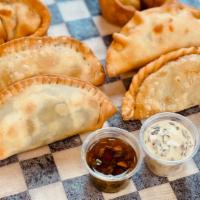 Spinach Empanada (Vg) · Spinach, onions, cream corn, black beans and Monterrey Jack cheese. Comes with a side of Chi...