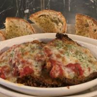 Eggplant Parmigiana · Lightly fried eggplant served in red sauce, topped with mozzarella, fresh grated parmesan ch...