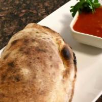 Pepperoni Calzone · Pepperoni, ricotta and mozzarella hand wrapped into a calzone, then baked in our wood fired ...