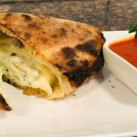 Spinach & Mushroom Calzone · Sautéed spinach & mushrooms, with ricotta & mozzarella cheese hand wrapped into a calzone an...
