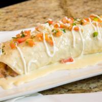 Burrito Bravo · A huge tortilla stuffed with grilled
chicken, Mexican sausage, rice
and beans, topped with c...