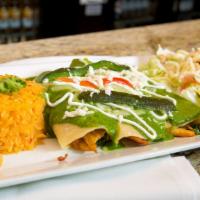 Spinach And  Chicken Enchiladas · Three corn tortillas stuffed with chicken
and spinach, topped with our delicious
roasted pob...