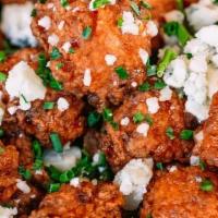 Buffalo Bites · BUFFALO CHICKEN BITES TOPPED WITH BLUE CHEESE CRUMBLES