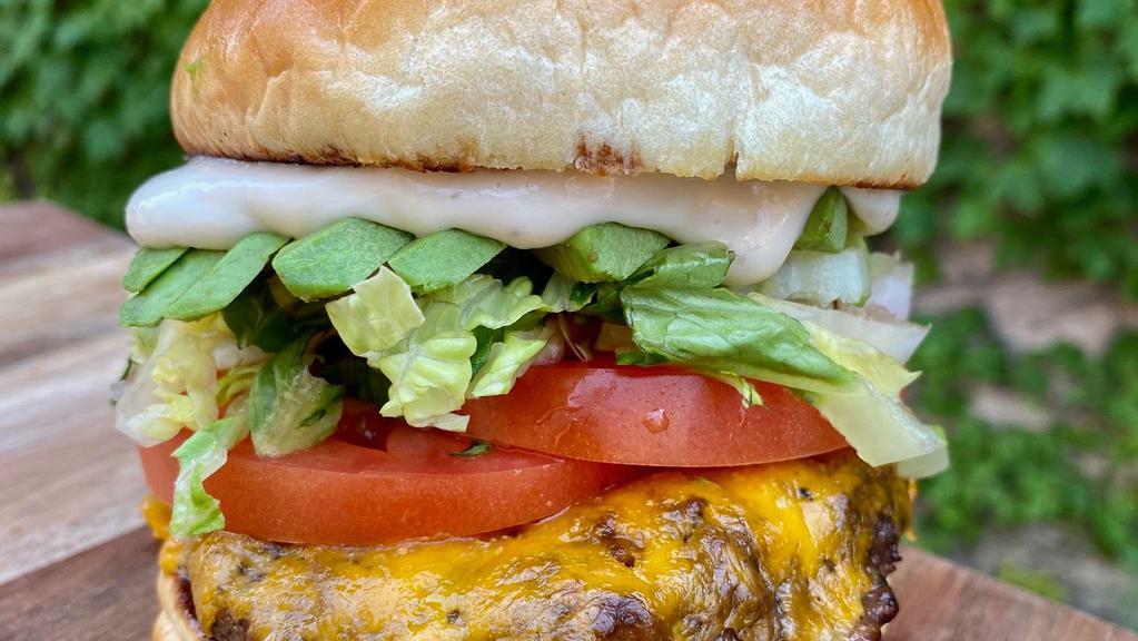 Classic Burger · 8 oz. Angus beef burger, Three Kings Dijonaisse, lettuce, pickles, and tomato on a brioche bun.