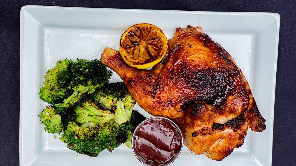 Broasted Chicken · Overnight brined half chickens, slow broasted and finished on our grill. Served with a side of charred garlic broccoli and BBQ Sauce.