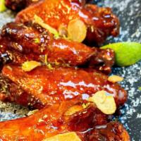 Korean Chili Wings · A staff favorite! This amazing sauce starts sweet and ends with heat. Tangy Pluck’d BBQ Sauc...