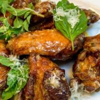 Italian Wings · Wings tossed with slow roasted garlic, aged parmesan cheese and fresh herbs.