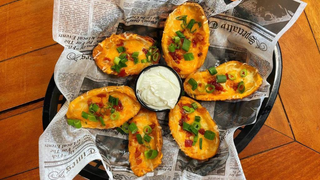 Loaded Potato Skins · Six skins loaded with bacon, melted cheese and scallions, served with a side of sour cream.