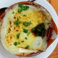 French Onion Soup · Melted provolone  and swiss cheeses served over house made garlic crouton and house made Fre...