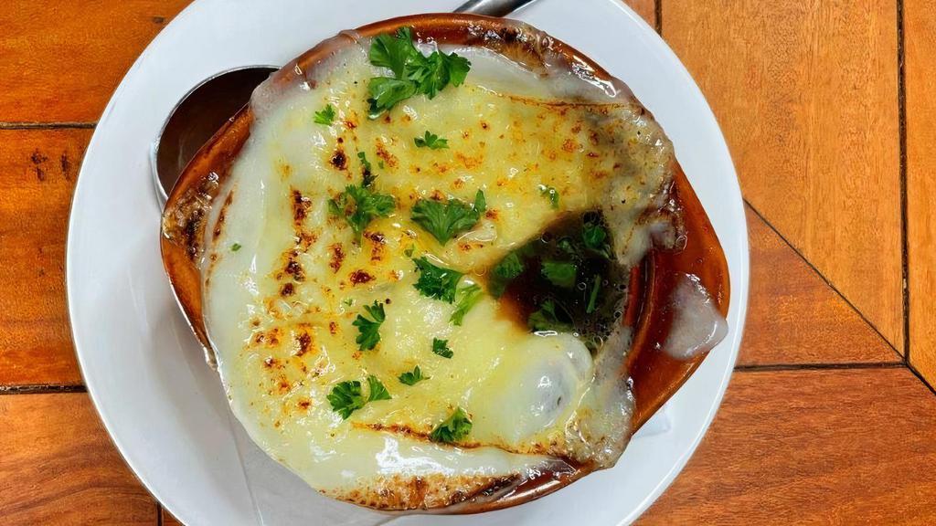 French Onion Soup · Melted provolone  and swiss cheeses served over house made garlic crouton and house made French onion soup.