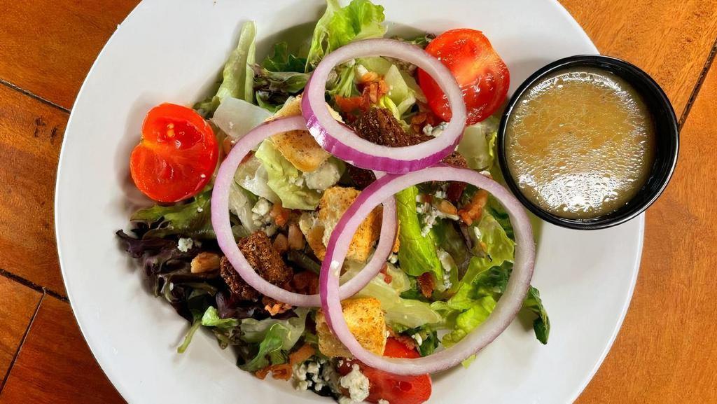 Pub House · Mixed greens topped with bacon, tomato, blue cheese, fresh red onion and croutons.