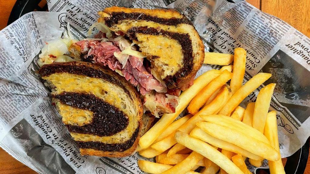 Traditional Reuben · House-made corned beef, swiss cheese, sauerkraut and 1000 island between two slices of grilled marble rye.