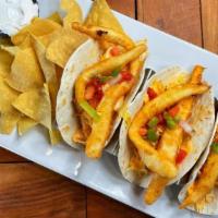 Fish Tacos · Our white fish, blackened or deep-fried, served inside three soft flour taco shells topped w...