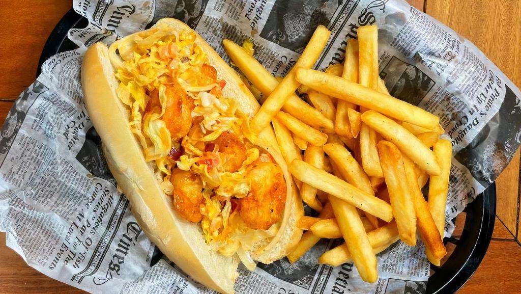 Shrimp Po' Boy · Crispy fried shrimp tossed with shredded lettuce, tomato, onion and cajun mayo, stuffed in a fresh hoagie roll. Served with your choice of side.