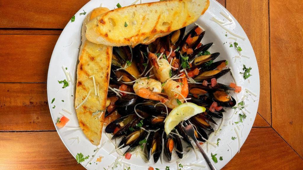 Mussels & Shrimp · Over a pound of mussels with shrimp steamed in white wine, butter and spices. Served with two slices of garlic bread for dipping.
