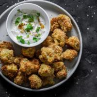 Popcorn Cauliflower Bites · Hand battered in rice flour tempura, these crispy bites are topped with black sesame seeds a...