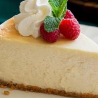 New York Supreme Cheesecake · Gloriously smooth, impossibly creamy new york style cheesecake rests in a graham cracker cru...