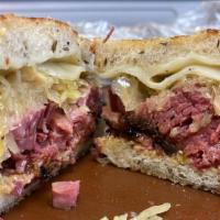 Reuben Sandwich · Smoked Corned beef on toasted rye bread with Thousand Island dressing, sauerkraut and swiss ...