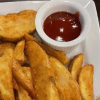 Potato Wedges · Marinated battered deep-fried wedges served with ketchup.