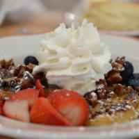 Biscuit French Toast · Maple syrup, whipped cream, candied pecans, fresh berries, powdered sugar.